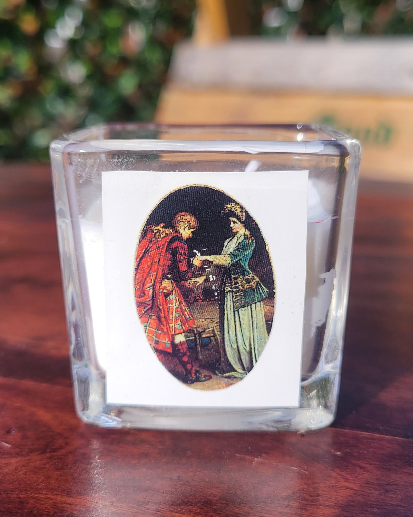 A GLH candle depicting a scottish couple in the midst of a courtship ritual.